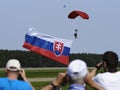 The parachutist flies with the Slovak flag behind him