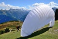 A parachutist prepares for a jump with open parachute.