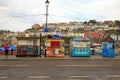 A parade of colourful fishing kiosks in Brixham, South Devon