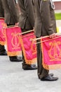 Parade of military orchestra holding musical instrument trumpet with red flag and golden lyre Royalty Free Stock Photo