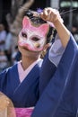 Parade participant wearing a cat mask