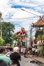 Parade on the street of Bali island. People carry a huge statue of a four-armed demon