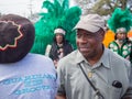 Paradegoer, Mardi Gras Indians and Guardians of the Groove at Uptown Super Sunday parade