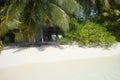 Paradisaic beach bungalow in tropical vegetation on barefoot island Royalty Free Stock Photo
