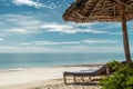 Paradise beach with sunbeds under umbrella Royalty Free Stock Photo