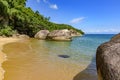 Paradisiac beach with transparent waters surrounded by tropical rainforest