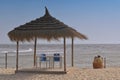 Umbrella, blue sky, sun. Tunisia, island Djerba. Royalty Free Stock Photo