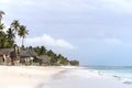 Paradise beach at Zanzibar island in Tanzania, Africa. White sand beach with buildings and palm trees, an amazing holiday Royalty Free Stock Photo