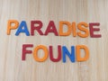 Paradise found sign on a wood background