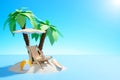 Paradise island in the ocean. Sun lounger, surfboard and ball under palm trees on the sand. Royalty Free Stock Photo