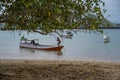 A Paradise island, tropical beach, emerald green sea with beach trees and blue sky background, Indonesia, south asia. Local people