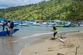 A Paradise island, tropical beach, emerald green sea with beach trees and blue sky background, Indonesia, south asia. Local people