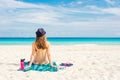 Paradise summer vacation happiness carefree happy woman relaxing sitting in sand enjoying tropical beach destination Royalty Free Stock Photo