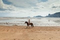 Beautiful woman on a horse. Horseback rider. Paradise tropical beach. Royalty Free Stock Photo