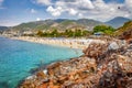 Paradise tropical resort beach in Alanya, Turkey. Sea and rocky mountains on turkish beach on summer sunny day with clouds Royalty Free Stock Photo