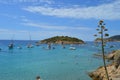 Panoramic seascape : beach with palette of blue, boats and small islet. Mallorca, Spain