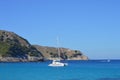 Panoramic view of boat, mountains, cliffs, sea and blue sky.