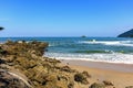 Paradisiacal rocky beach with clean and calm waters in Bertioga