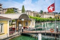 Paradiso pontoon with flag and people waiting for a lake boat in Paradiso Lugano Ticino Switzerland