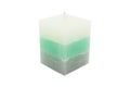 A paraffin small, square, candle in sea color lies on a white background with a clipping path.