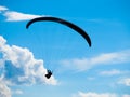 Paraglide silhouette with blue sky and white clouds Royalty Free Stock Photo