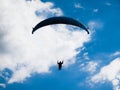 Paraglide silhouette with blue sky and white clouds Royalty Free Stock Photo