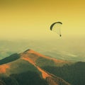 Paraglide silhouette in a Carpathian mountains. Vintage