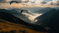 Paraglide silhouette flying over Carpathian peaks and clouds