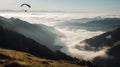 Paraglide silhouette flying over Carpathian peaks and clouds