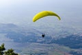 Paraglide silhouette flying over misty mountain