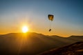 Paraglide silhouette in a light of sunrise above the Carpathian mountains