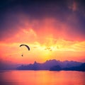 Paraglide silhouette over the sea sunset