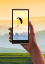 Paraglide silhouette on a screen of smartphone