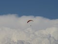 Paraglider above storm clouds.