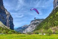 Paraglider in the blue sky. The sportsman flying on a paraglider