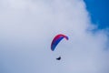 Paraglider flies in the air -Aerial view of paraglider above the clouds