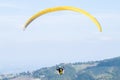 Paraglider flies in the air -Aerial view of paraglider above the mountains