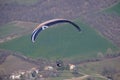 Paraglider flies in the air -Aerial view of paraglider above the mountains