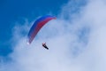 Paraglider flies in the air -Aerial view of paraglider above the clouds