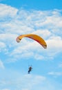 Paraglider flies in the blue sky Royalty Free Stock Photo