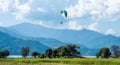 Paraglider flies over a meadow, Pokhara, Nepal Royalty Free Stock Photo