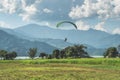 Paraglider flies over a meadow, Pokhara, Nepal Royalty Free Stock Photo