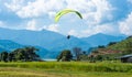 Paraglider flies over a meadow, Pokhara, Nepal Royalty Free Stock Photo