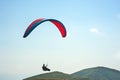 Paraglider flies over a mountain valley on a sunny summer day. P Royalty Free Stock Photo