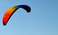 Paraglider flight through the blue sky Royalty Free Stock Photo