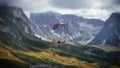 Paraglider in flight on the side of Mount Seceda in Dolomites, Italy