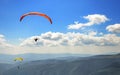Paraglider floating in the air against the sky. Royalty Free Stock Photo
