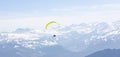 Paraglider Fly in the Mountains as snow apls mountain background Royalty Free Stock Photo