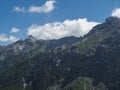 Paraglider fly over limestone mountain peaks. Kiting in blue and orange kite in Stubai valley Tirol Alps, Austria Royalty Free Stock Photo