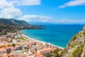 Paraglider flying above the amazing landscape of coastal city Cefalu in beautiful Sicily. Paragliding is a popular extreme sport. Royalty Free Stock Photo